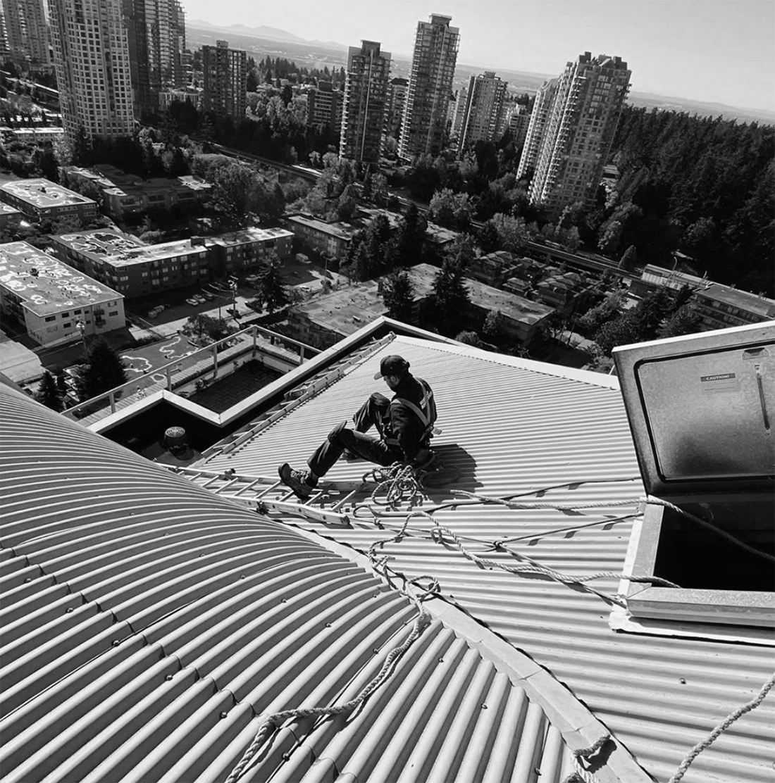 Roofer on top of a building.